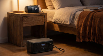 Portable power station on floor powering a CPAP machine on the nightstand