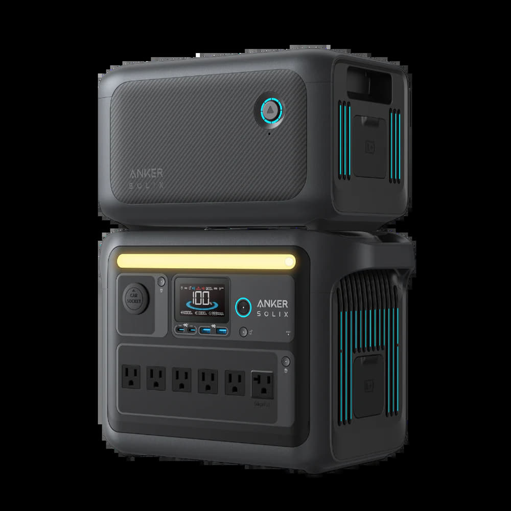 A stack of two Anker power devices, designed for off-grid living, features a bottom unit reminiscent of the Anker SOLIX C1000X. This includes a digital display, multiple outlets, and turquoise accents. The top unit showcases a textured surface and a circular button with modern design elements.