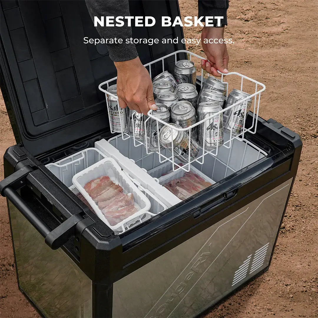 The BougeRV cooler, a portable marvel reminiscent of a dual-zone fridge, is open on the ground. Inside, a wire basket holds several cans of sparkling water, while raw meat is organized in two separate compartments.