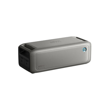 An Anker rectangular gray portable Bluetooth speaker is displayed against a white background, featuring a mesh front, side control buttons, blue power indicator light, and backup power for longer playtime.