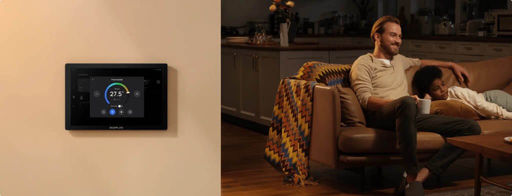 EcoFlow PowerInsight Home Energy Manager touchscreen displayed on wall, with a family relaxing on a couch in the background.