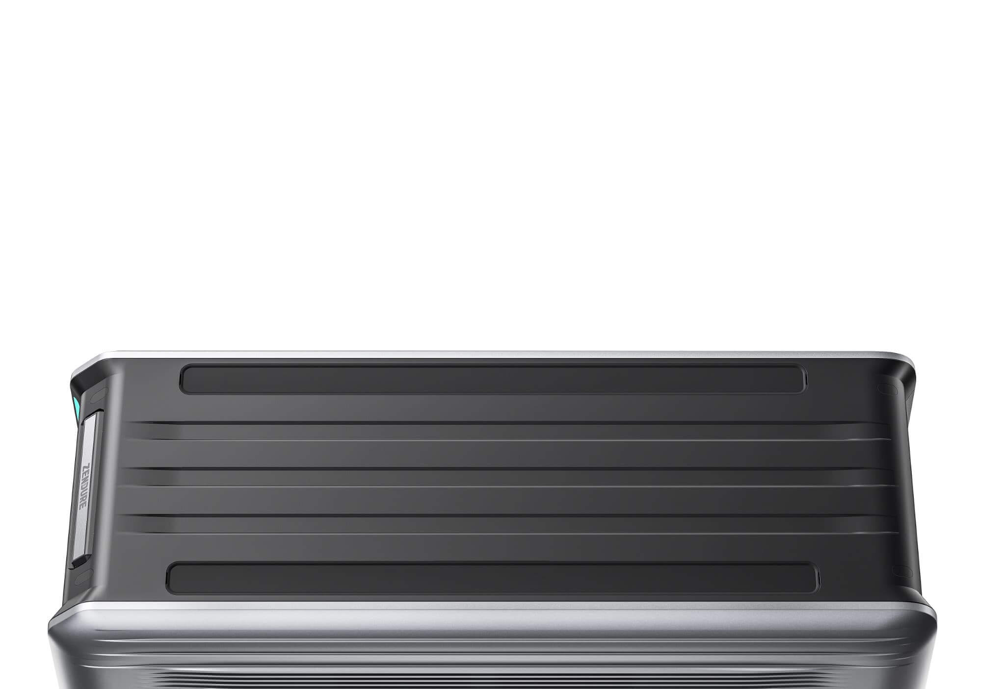 A close-up of the top section of a hard-shell suitcase with horizontal ridges, a black finish, and silver accents—like the Zendure brand—set against a white background.