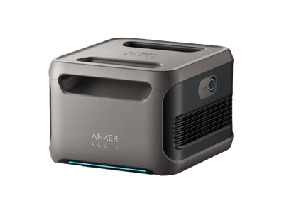 The Anker SOLIX BP3800 is a compact, gray device with a minimalist design featuring an 840Wh LFP battery. It includes a top handle, side ventilation, and a lens on one side, with the brand name Anker prominently displayed on the front.