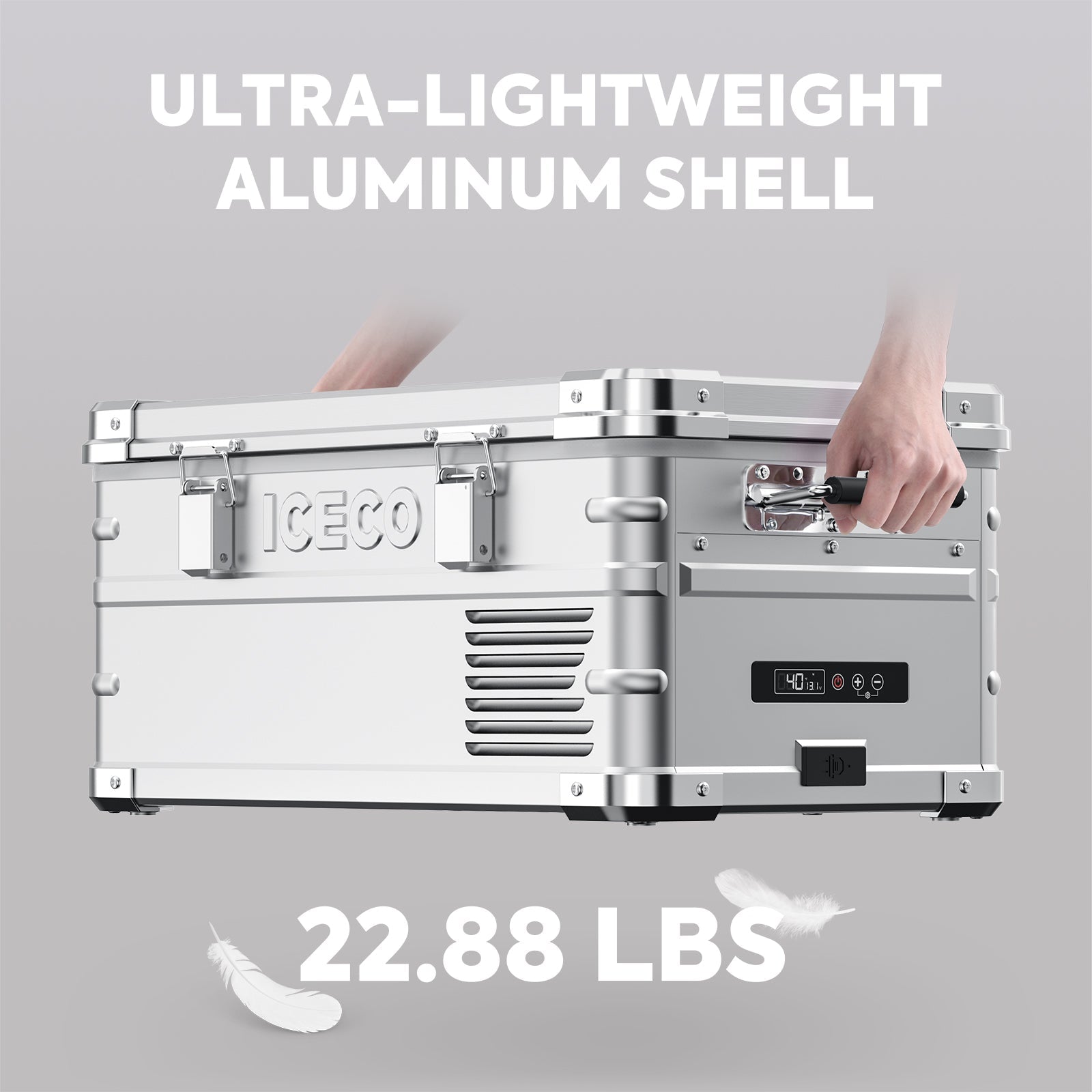 A person lifts a silver, rectangular ICECO Wholesale box with "ULTRA-LIGHTWEIGHT ALUMINUM SHELL" above, featuring its digital display and secure latches. This Aluminum Freezer offers a deep cooling range. Text at the bottom reads "22.88 LBS," with feather graphics emphasizing its portability.