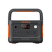 The Jackery Explorer 600 Plus is a black portable power station with orange accents, featuring a display screen for charge level, two AC outlets, multiple USB ports, and a DC input.