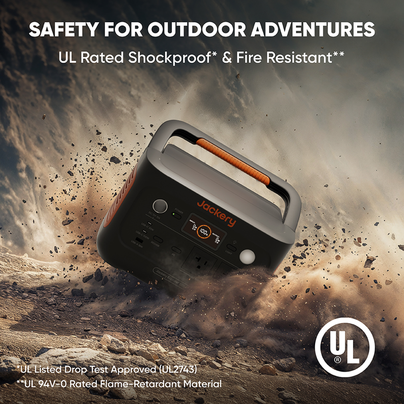 A Jackery portable power station with an orange handle is pictured on rocky terrain, showcasing its UL-rated shockproof and fire-resistant features for outdoor safety. Visible are the UL certification logos.