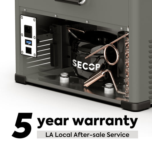 Close-up view of the internal components of an ICECO Wholesale Secop compressor unit in a dual-zone portable fridge freezer, featuring visible copper coils and wiring. Text in the image states "5 year warranty" and "LA Local After-sale Service.