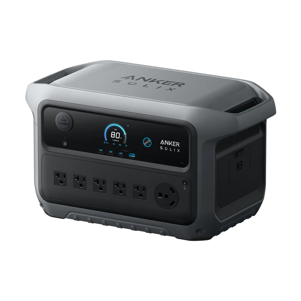 An Anker portable SOLIX power station featuring a digital display, control button, multiple AC outlets, and a rugged gray and black exterior is shown on a plain white background.