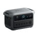 An Anker Solix portable power station in gray features a digital display, six AC outlets, a circular outlet, and multiple side ports, all set against a plain white background.