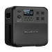 A Bluetti portable power station in black, featuring a digital display, control buttons, four AC outlets, and a textured surface, displayed against a plain white background.