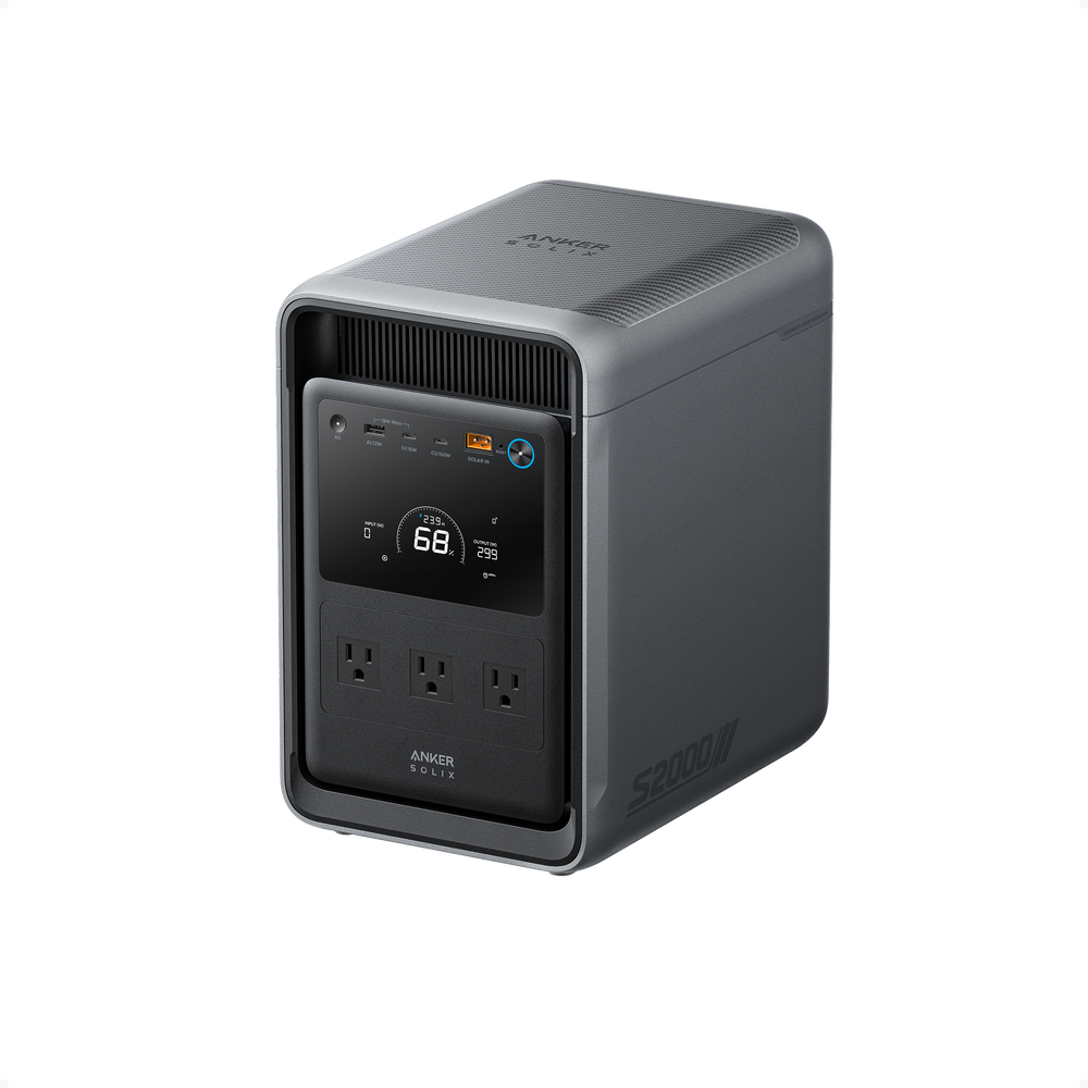 A gray Anker portable power station, model SOLIX S2000, featuring a digital display, three AC outlets, multiple ports, and a top-mounted carrying handle is shown against a plain white background.