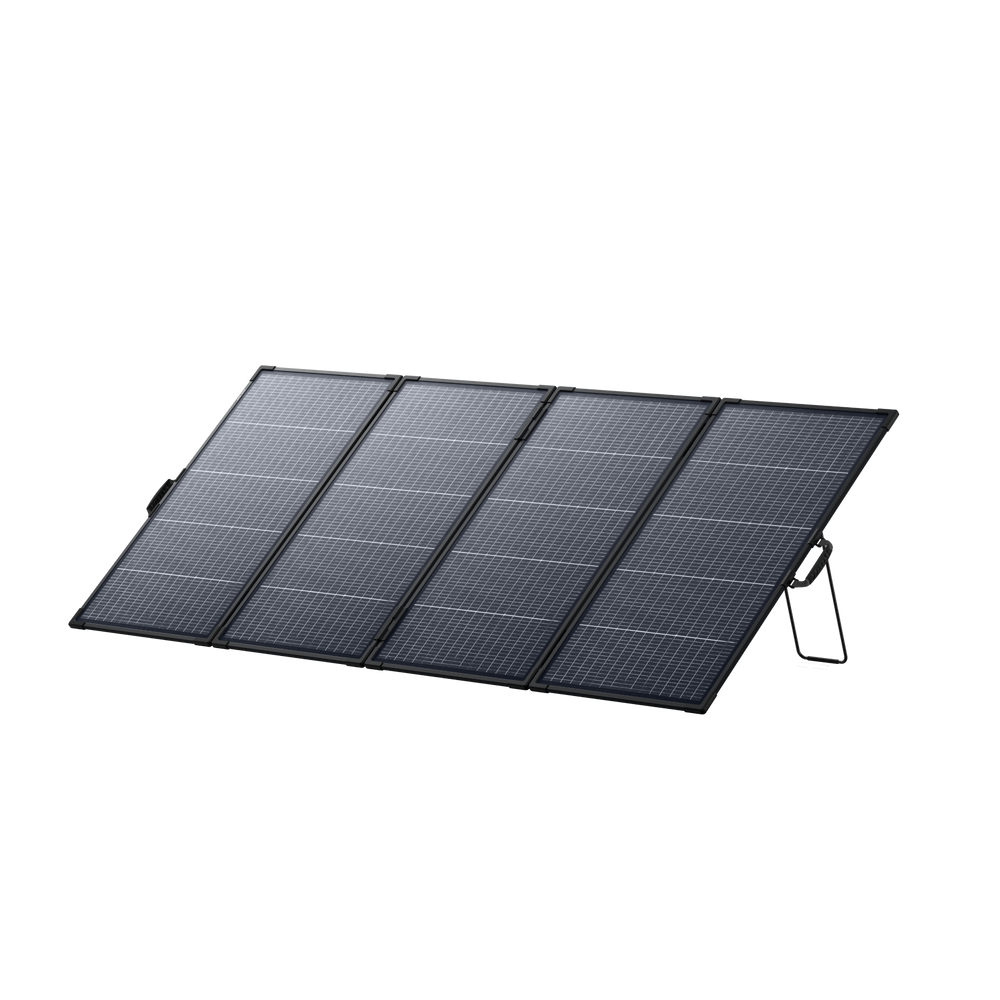 A foldable Anker portable solar panel with four dark rectangular sections is set up on a white background, supported by two built-in metal stands.