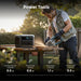 A man uses an Anker portable power station to run a circular saw on a wooden plank outdoors. Icons below show runtimes for tools like mowers, drills, chainsaws, and saws in hours.