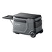 The Anker Solix portable power station in gray features wheels, a pull-out handle, multiple compartments, and a control panel on the top right. It's ideal for pairing with an electric cooler and is shown against a white background.