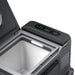 An Anker open portable solar cooler featuring a digital control panel with temperature display, interior LED lighting, and an empty compartment is shown in a well-lit environment.