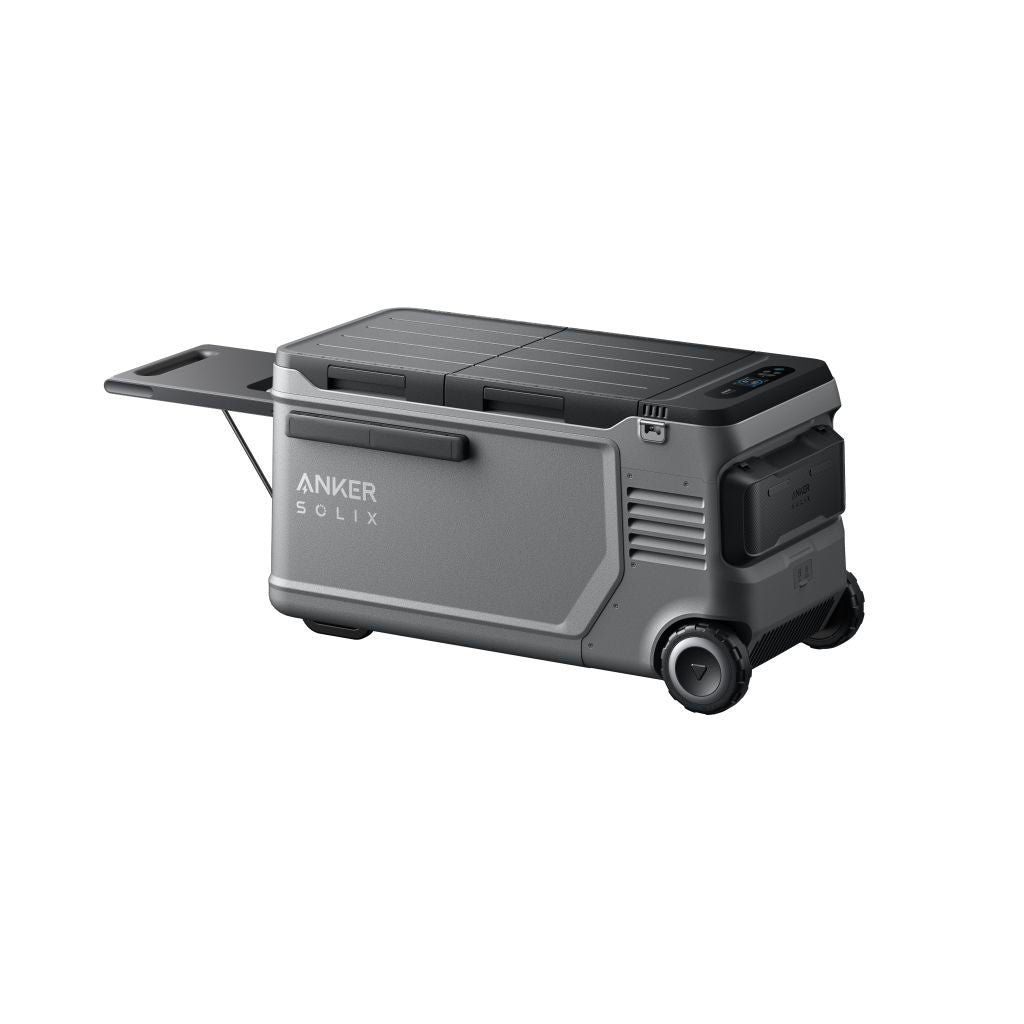 The Anker Solix is a gray portable power station with wheels, a pull handle, and an extendable side tray. It features control buttons and ports on one end.