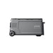 A gray Anker portable power station is pictured from the side, featuring a flat rectangular design, two visible wheels on one end, and the brand name "Anker" printed on its side.