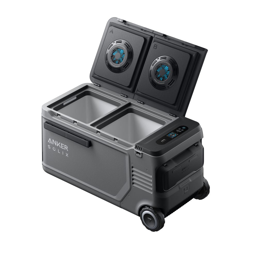 A portable gray Anker Solix cooler with two open compartments and lids, built-in wheels, side handle, control panel, and dual lid fans is shown on a white background.