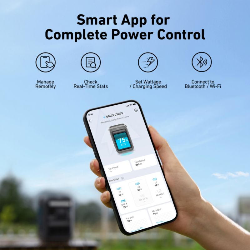 A hand holds an Anker smartphone showing a power management app, with a blurred outdoor background. Text highlights features like remote management, real-time stats, and seamless Bluetooth/Wi-Fi connectivity.