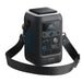 A black Anker portable power station with a digital display, multiple ports and buttons, a carrying handle, and an attached shoulder strap—styled like modern web design. The device features the Anker logo at the bottom.