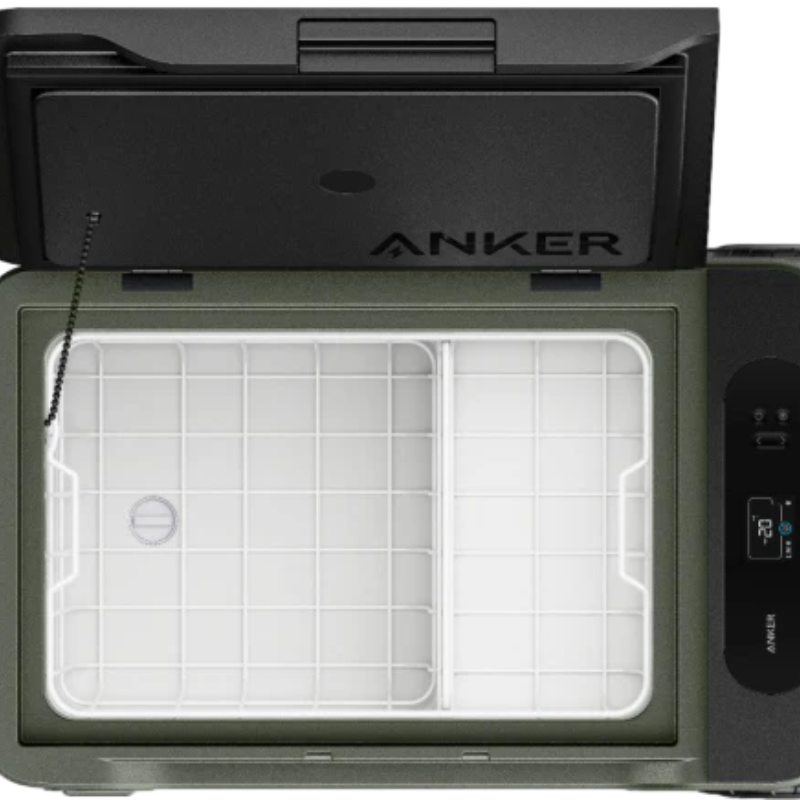 Top view of an open Anker portable cooler from the EverFrost series. The inside is empty and features a grid pattern on the bottom. The lid is ajar, displaying the Anker brand logo. On the right side, a digital display reads "77°F," emphasizing its battery-powered functionality.