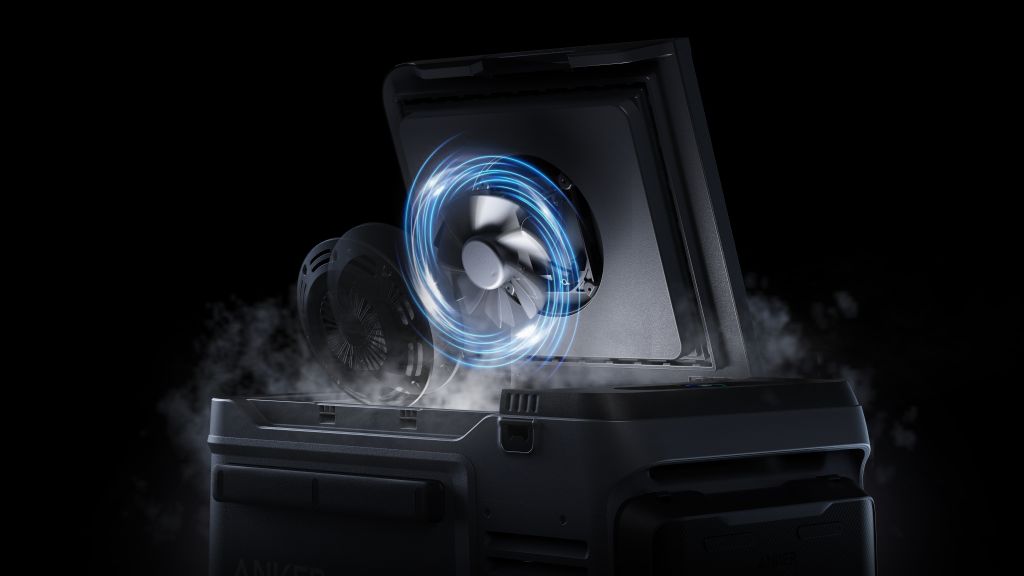 A close-up of the Anker portable solar cooler with its lid open, showing an internal fan with blue motion lines and mist or smoke coming out, set against a black background.