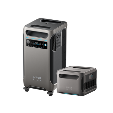 Two Anker portable power stations are displayed. The larger unit on the left, similar to the Anker SOLIX F3800 model, features a digital display and multiple ports, complete with small wheels for easy mobility. The smaller unit on the right has a more straightforward design. Both units are gray with futuristic accents and are ideal for integration with solar panels.