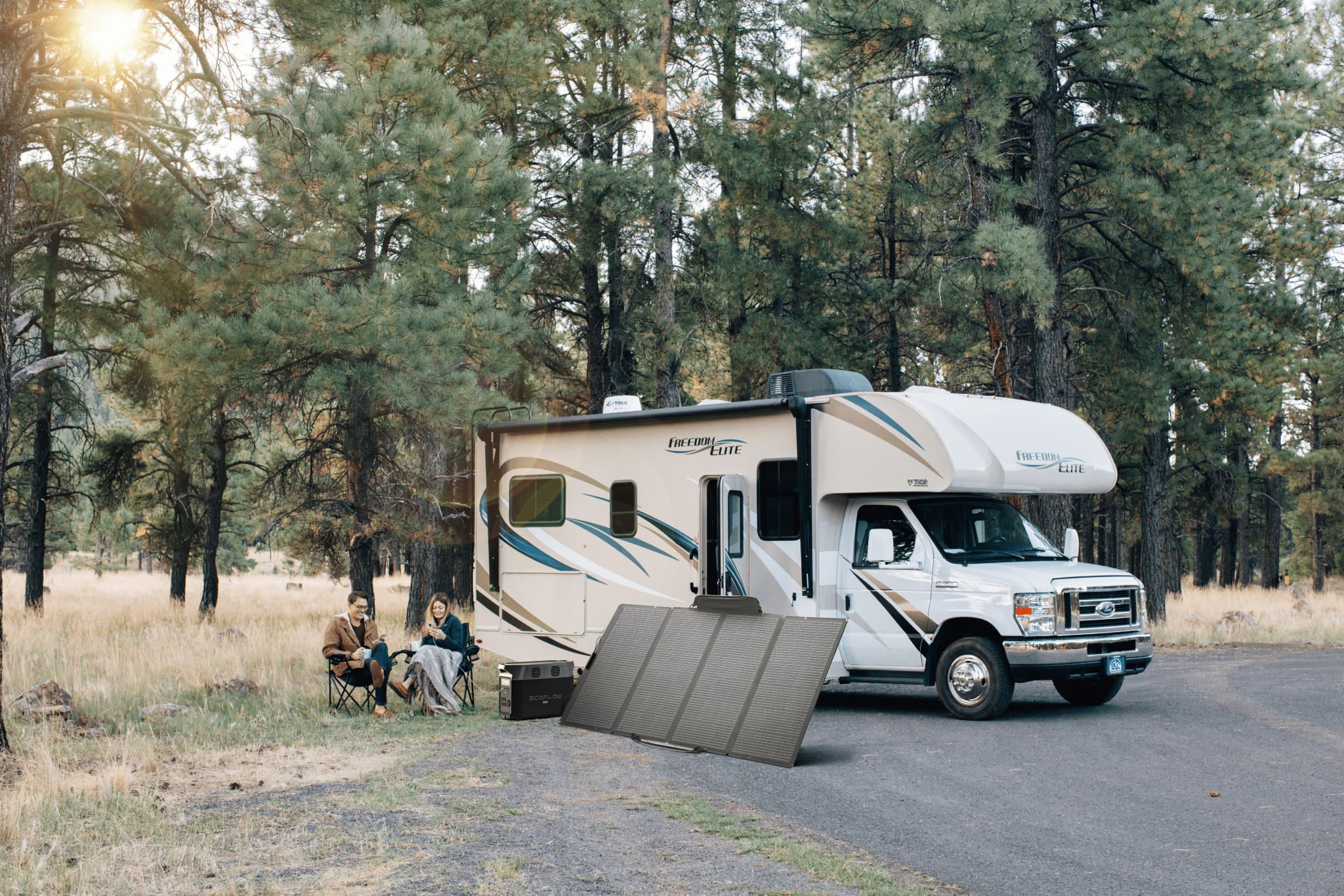 EcoFlow DELTA Pro with a portable solar panel charging beside an RV at a campsite