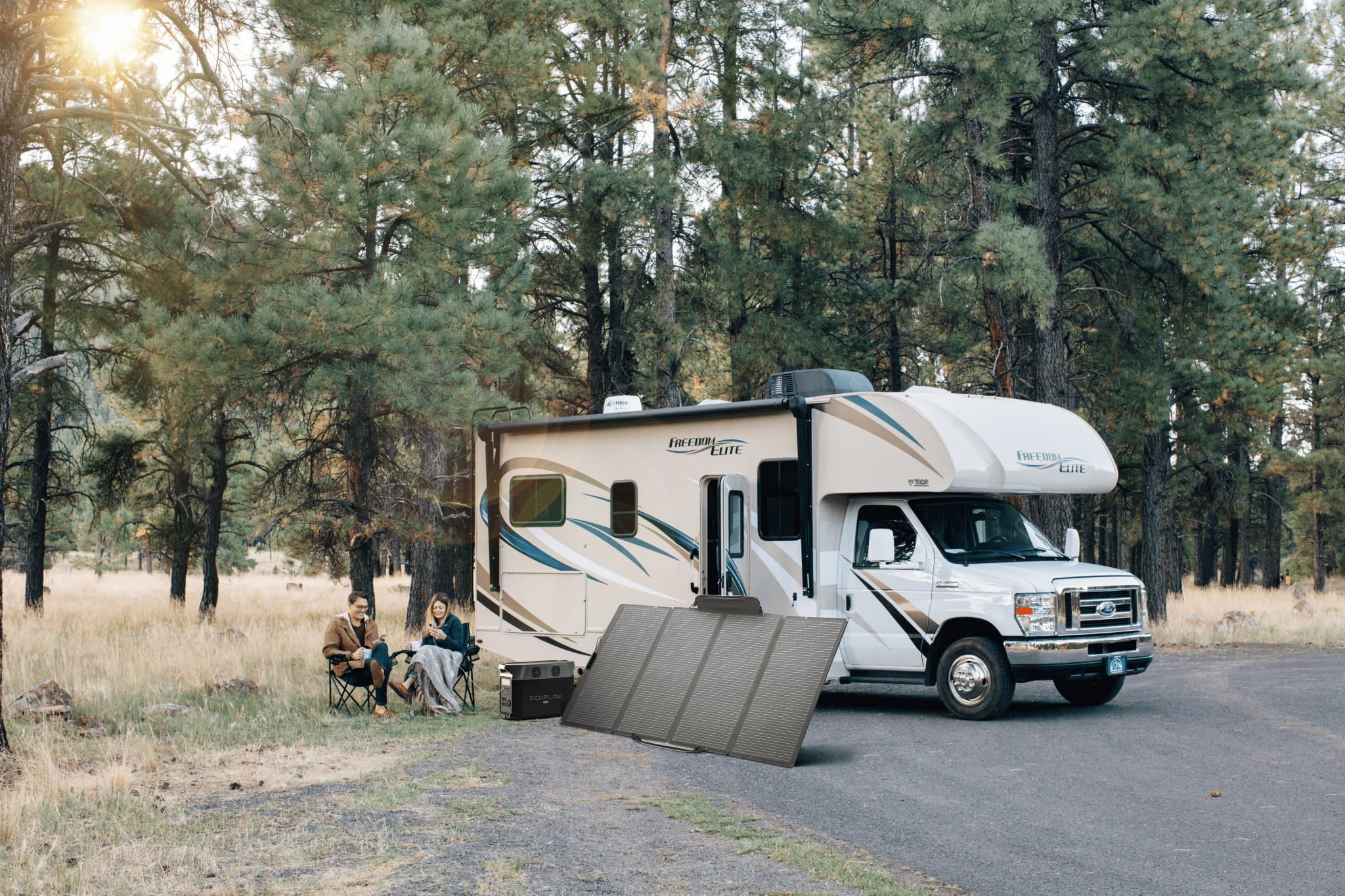 EcoFlow DELTA Pro with a portable solar panel charging beside an RV at a campsite