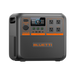 A portable Bluetti power station featuring a digital display, four AC outlets, and multiple input/output ports on the front panel. The device is finished in black with orange accents and has a textured surface.