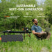 In a grassy field, a man sits on a chair with a laptop on his lap. Beside him, a table holds a Jackery portable generator. Highlights: "Sustainable Next-Gen Generator," "Whisper Quiet," "Emission Free," and over 150,000 global five-star customer ratings.