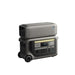 Anker portable power station with wheels, handle, digital display, and multiple outlets, stacked with a rectangular gray device—both in gray—set against a white background.