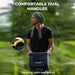 A person wearing a beanie is holding the BougeRV Portable Power Station, designed with dual handles for easy carrying. A blurred green outdoor background emphasizes its practicality, complemented by text that reads "1200W Output" and "Move with ease.