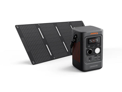 A black Jackery portable power station with multiple outlets and ports is displayed beside a matching foldable solar panel, forming a complete solar solution. The Jackery logo appears on the power station.