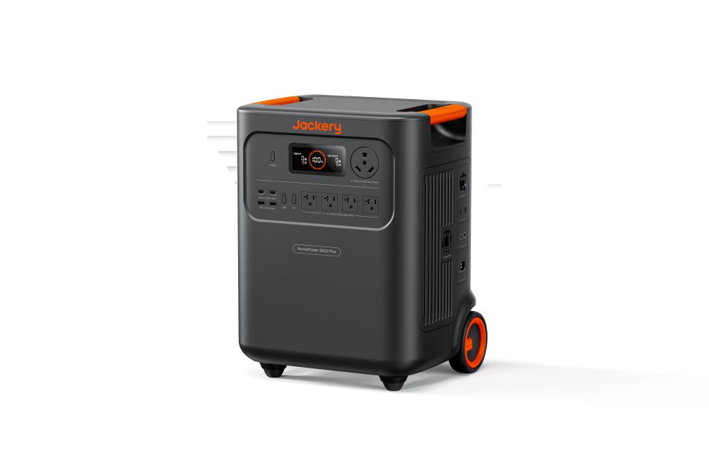 The Jackery portable power station features backup power, multiple outlets, a digital display, and an orange-accented handle and wheels, shown on a plain white background.