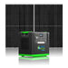 The Nature’s Generator portable solar generator, featuring LiFePO4 battery, display screen, green accents, and multiple power outlets, is shown in front of two large solar panels on a white background.
