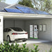 A white electric car is parked in a modern garage with solar panels and Nature's Generator LiFePO4 battery storage units on the wall; shrubs are in the foreground and trees appear in the background.