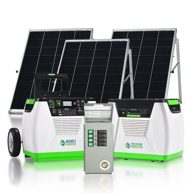 Two solar panels stand behind two white and green Nature's Generator power stations labeled “Nature’s Generator” and “Power Pod,” providing an eco-friendly backup energy solution. A gray electrical control box sits in front of the units.