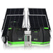 Two Nature's Generator portable solar generators with control panels and wheels stand before four large solar panels, highlighting off-grid power solutions. A small gray electrical panel sits between the generators. All feature black and green accents.