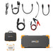 Image showcasing a portable Pecron power station kit equipped with a durable LiFePO4 battery. The set includes a rectangular power station with orange accents, an assortment of charging cables, jumper cables, and a compact device. The black carrying case prominently features the "Pecron" brand name, ideal for solar charging while traveling.