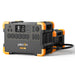 The Pecron portable power station, highlighted with yellow accents, includes a variety of outlets and a digital display. The Pecron E2000 model offers solar charging capabilities powered by a durable LiFePO4 battery. Additionally, it comes with a connecting cable to link to a smaller unit in the background for continuous portable power.