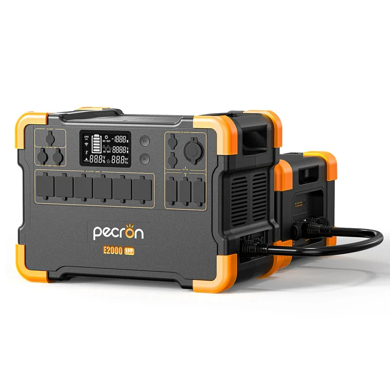 The Pecron portable power station, highlighted with yellow accents, includes a variety of outlets and a digital display. The Pecron E2000 model offers solar charging capabilities powered by a durable LiFePO4 battery. Additionally, it comes with a connecting cable to link to a smaller unit in the background for continuous portable power.