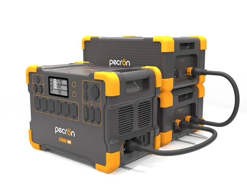 A collection of Pecron black and orange portable power stations highlights a 3072Wh LiFePO4 battery, interconnected by cables. The front unit, perfect for a sustainable lifestyle, boasts multiple outlets and a digital screen display.