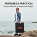 A man stands on rocky ground by the sea, holding a Jackery solar generator case. The text above reads: "PORTABLE & PRACTICAL. Outdoor enthusiasts can easily carry this Jackery energy solution thanks to its ergonomic design.
