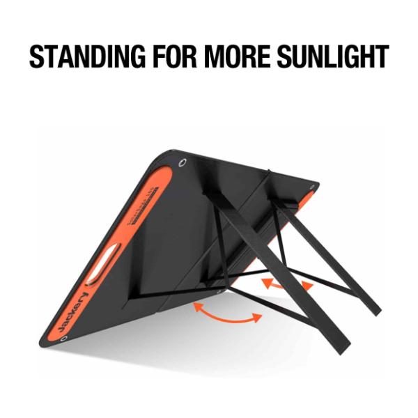 A Jackery solar panel stands on adjustable legs, optimizing its angle toward the sun. Above, bold text states, “STANDING FOR MORE SUNLIGHT.” Orange arrows highlight the portable energy solution’s easy adjustment mechanism.
