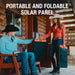 A man and woman in cowboy hats hold a Jackery bifacial, portable, and foldable solar panel outside a wooden cabin. Text above them reads "PORTABLE AND FOLDABLE SOLAR PANEL.
