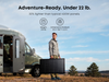 Anker SOLIX PS400 Bifacial Solar Panel folded and carried beside a camper van