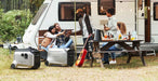 Group of people camping with EcoFlow Dual Fuel Smart Generator 4000 next to an RV