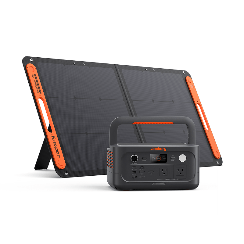 A Jackery portable solar panel with orange accents stands next to the compact black Jackery E500v2 backup power station, which features multiple ports, outlets, a handle, and prominent Jackery branding on both products.