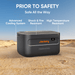 A Jackery Explorer 1000 Plus battery pack rests on sand under a clear sky, featuring advanced cooling, shock and fire resistance, and high temperature durability as a reliable Lithium Iron Phosphate Battery by Jackery.